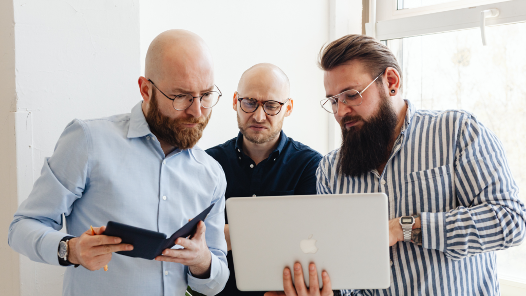 3 men looking at the computer