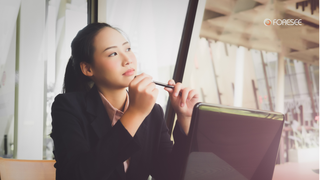 Woman contemplating in front of a laptop